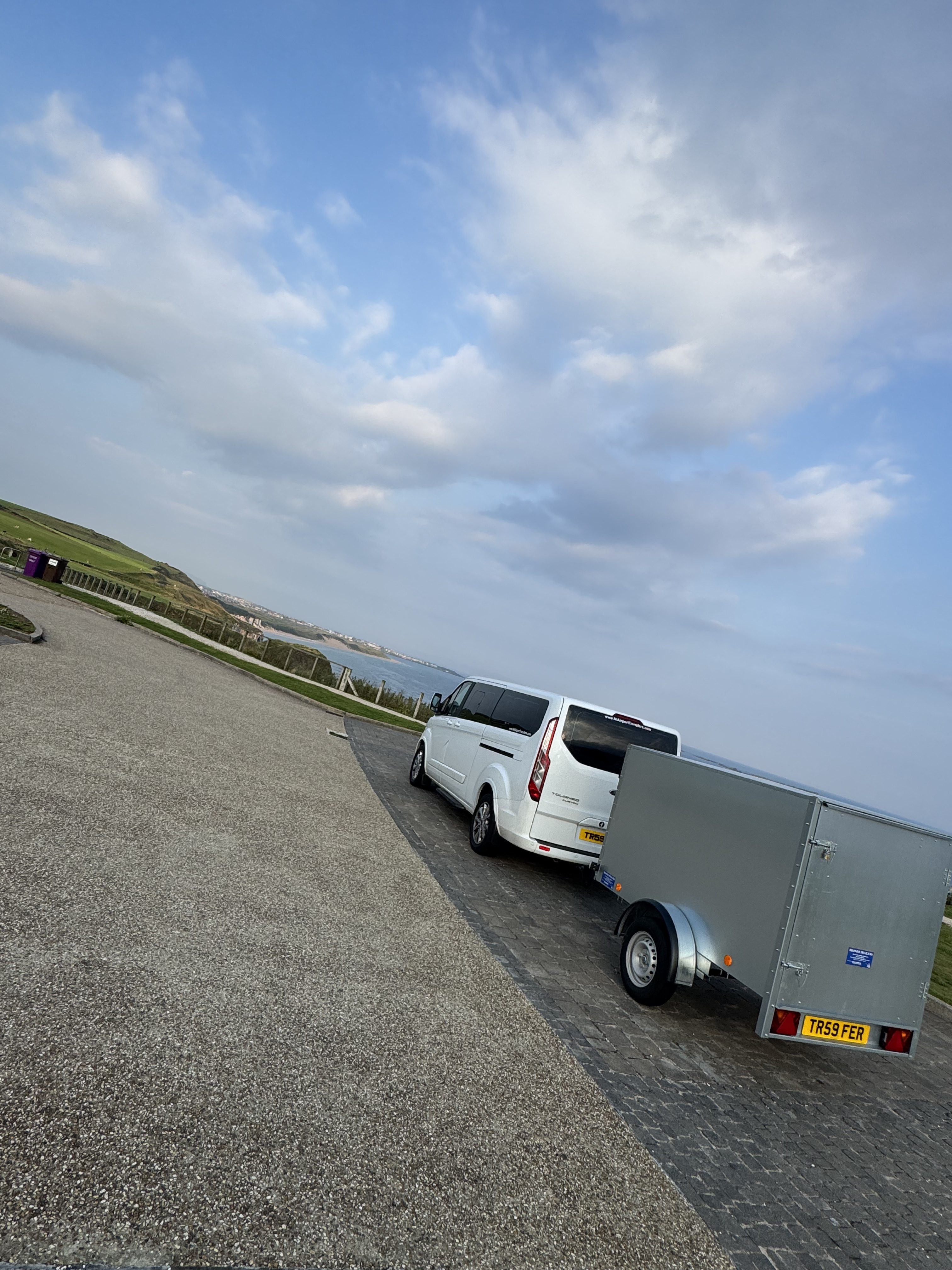 NI Airport Transfers Ford Tourneo Custom towing its enclosed equipment trailer