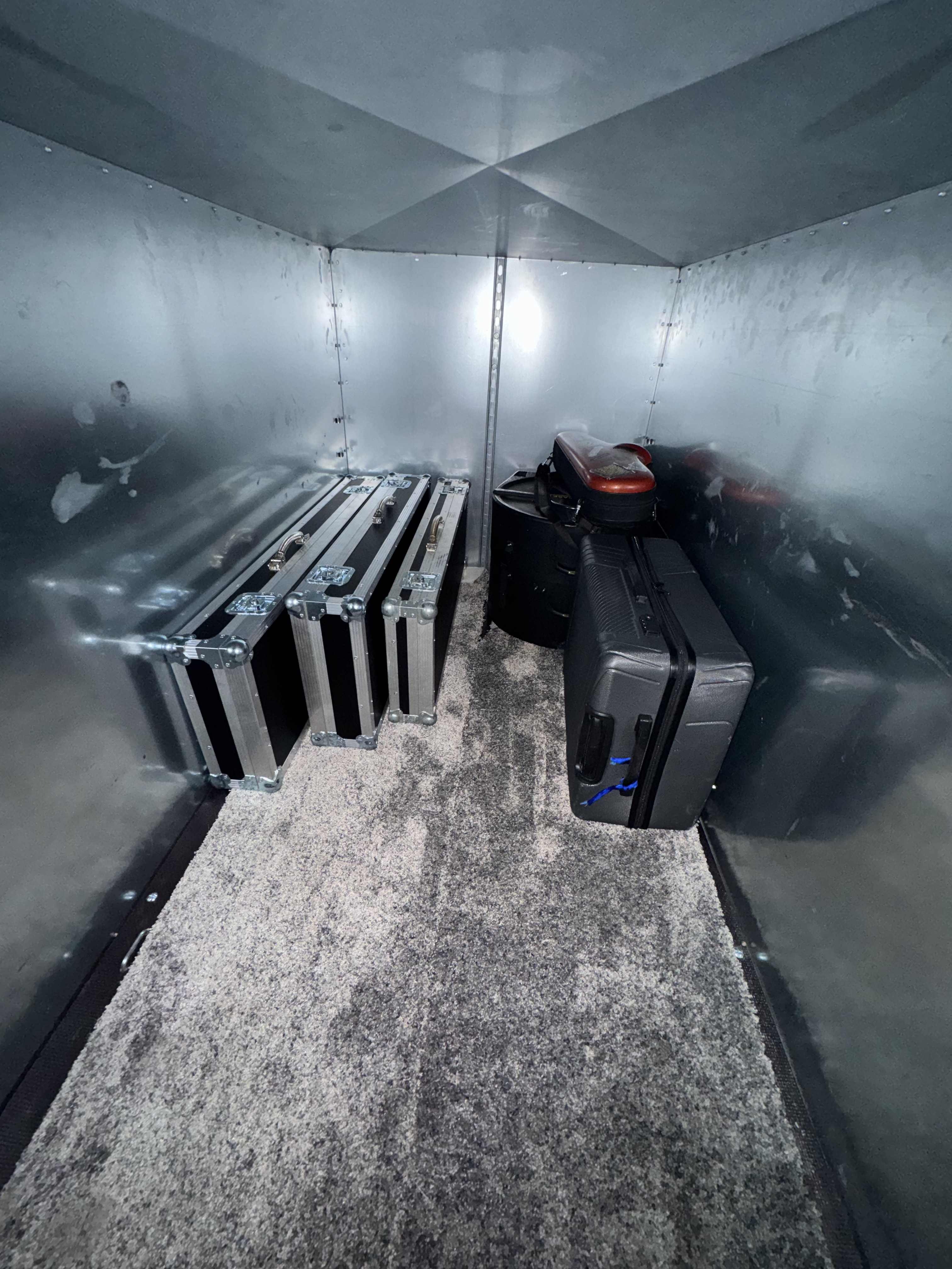 Enclosed NI Airport Transfers trailer carrying flight cases and equipment cases
