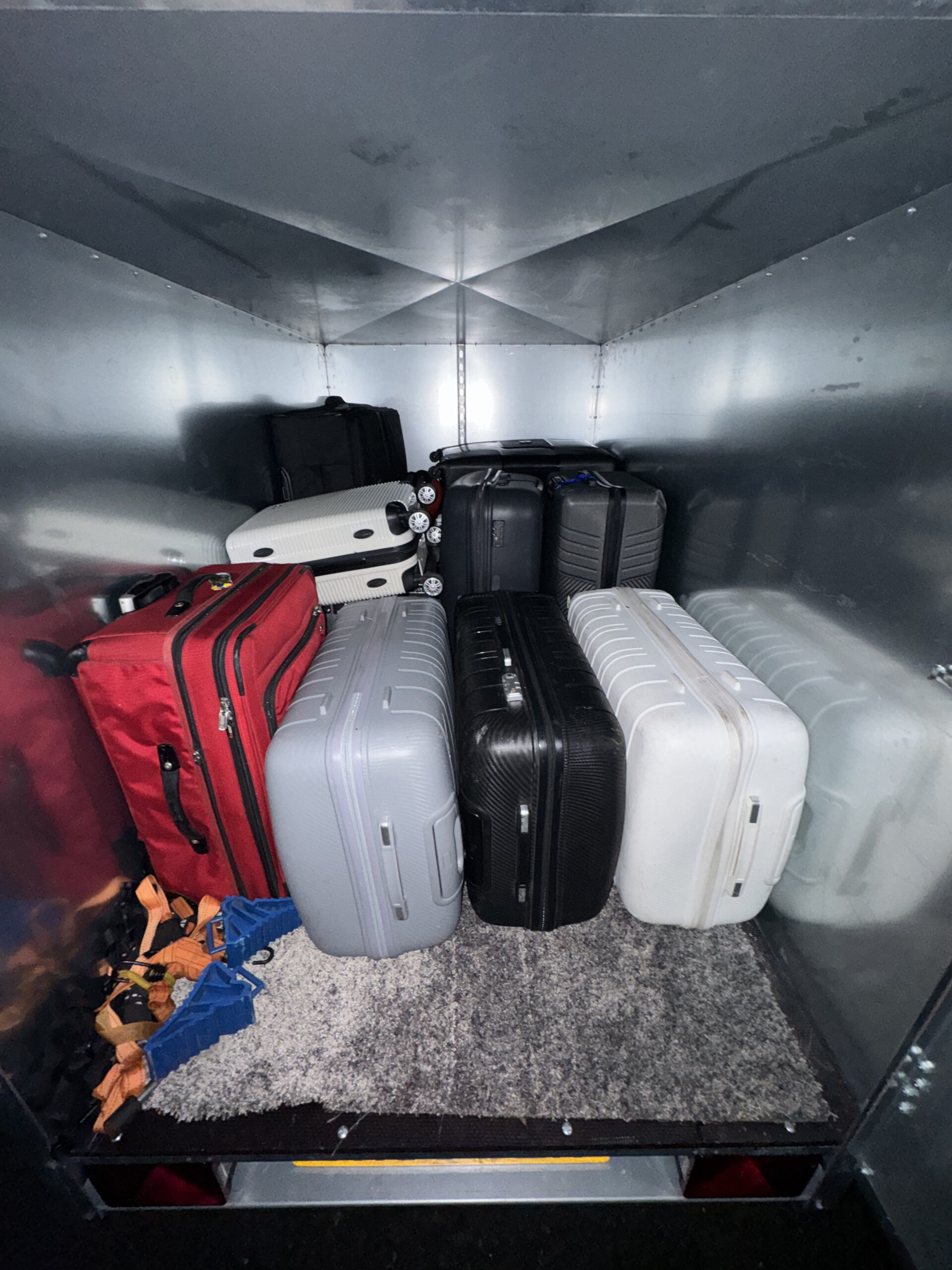 Enclosed NI Airport Transfers trailer loaded with customers' suitcases